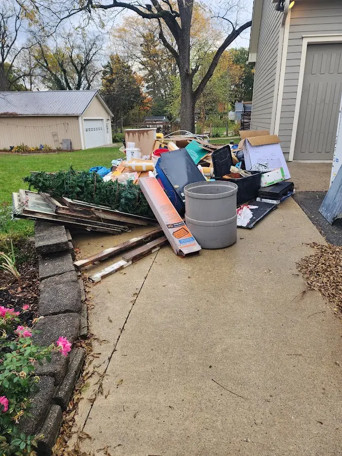 Dumpster being loaded with debris for Estate Cleanout Dumpster Rental in Wauna